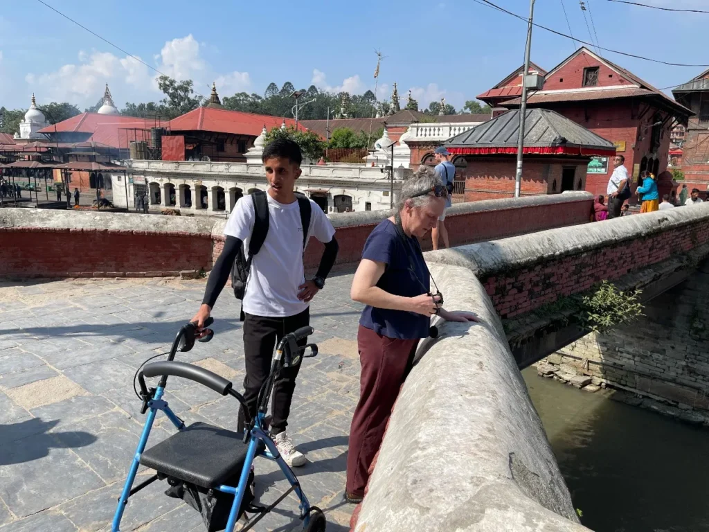 Professional carer supporting a traveler during an accessible holiday in Nepal